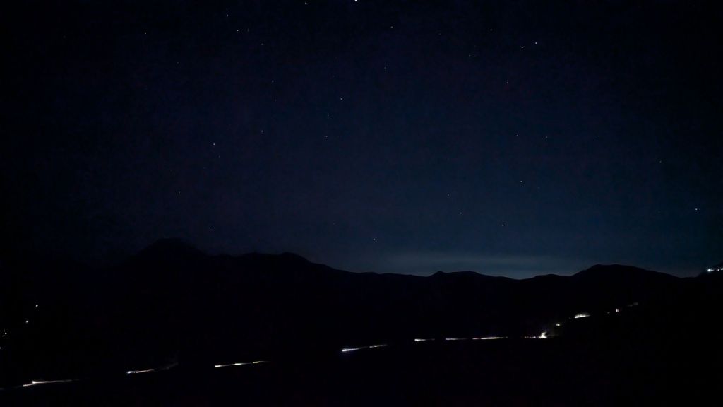 barely able to see anything in the dark, just the lights from the road below