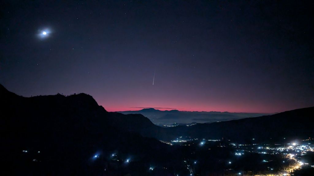 Comet C/2023 A3 (Tsuchinshan-ATLAS) visible over a red sunrise in East Java, Indonesia